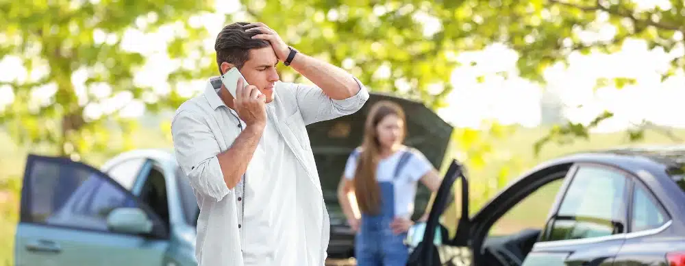 A man and woman standing beside their cars who may need a car accident lawyer in Clermont, FL.